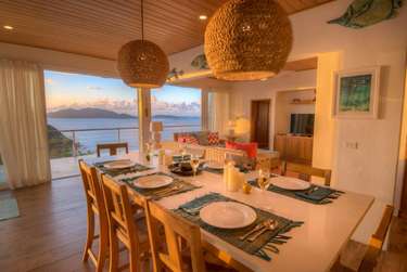 Dining area with panoramic water views and cozy ambiance