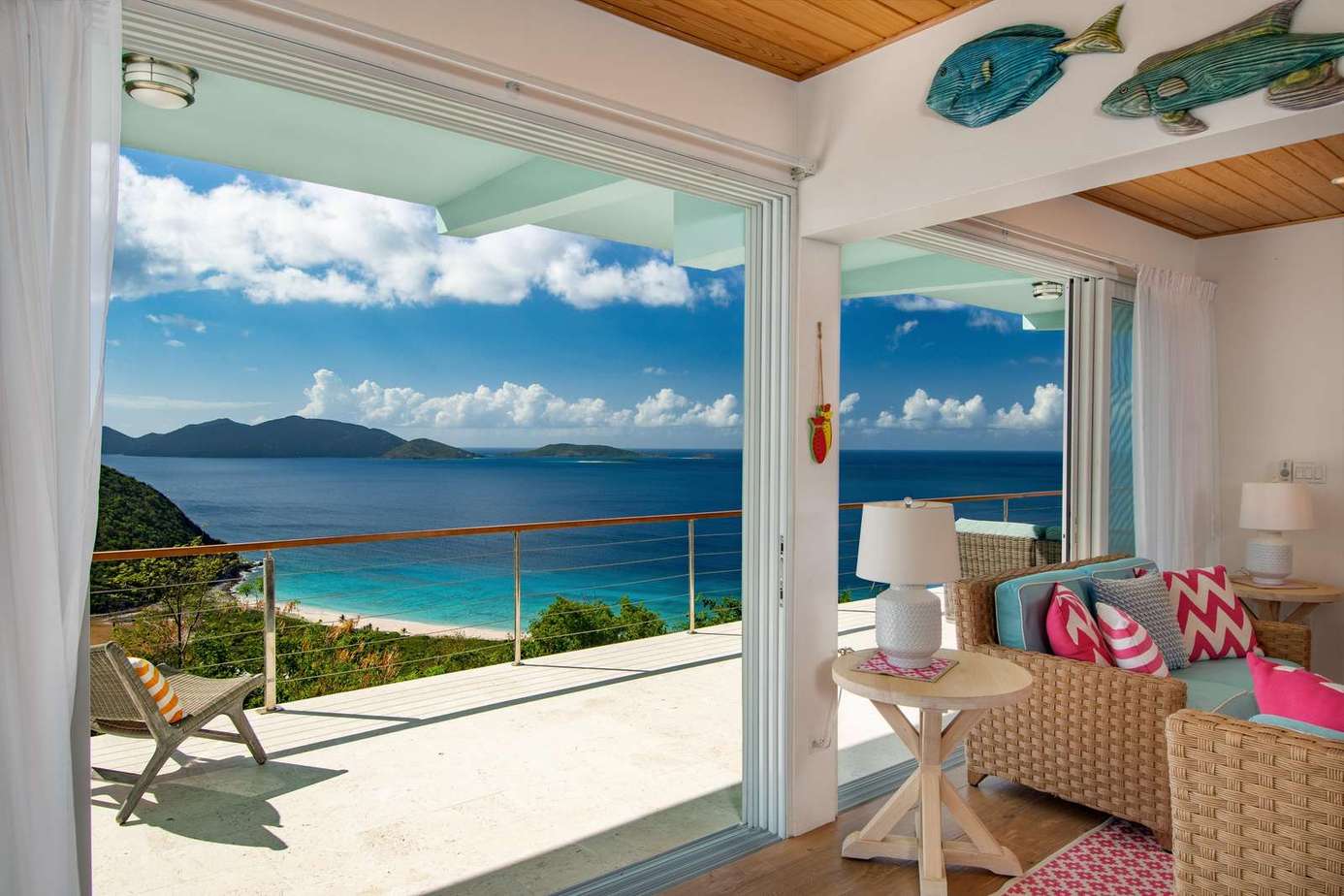 Sunlit living room with panoramic ocean views and breezy patio access