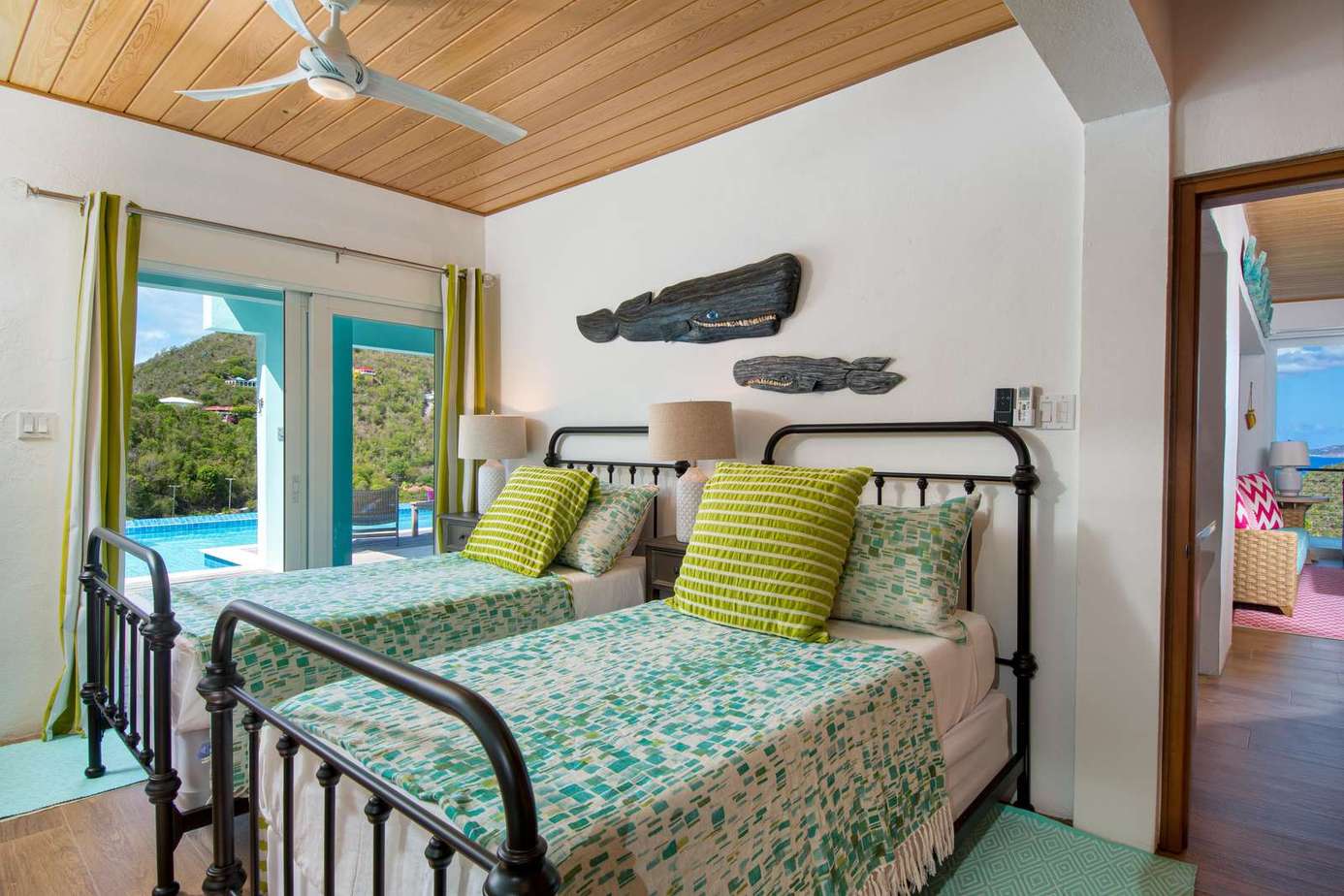Cozy twin bedroom with vibrant decor and garden views