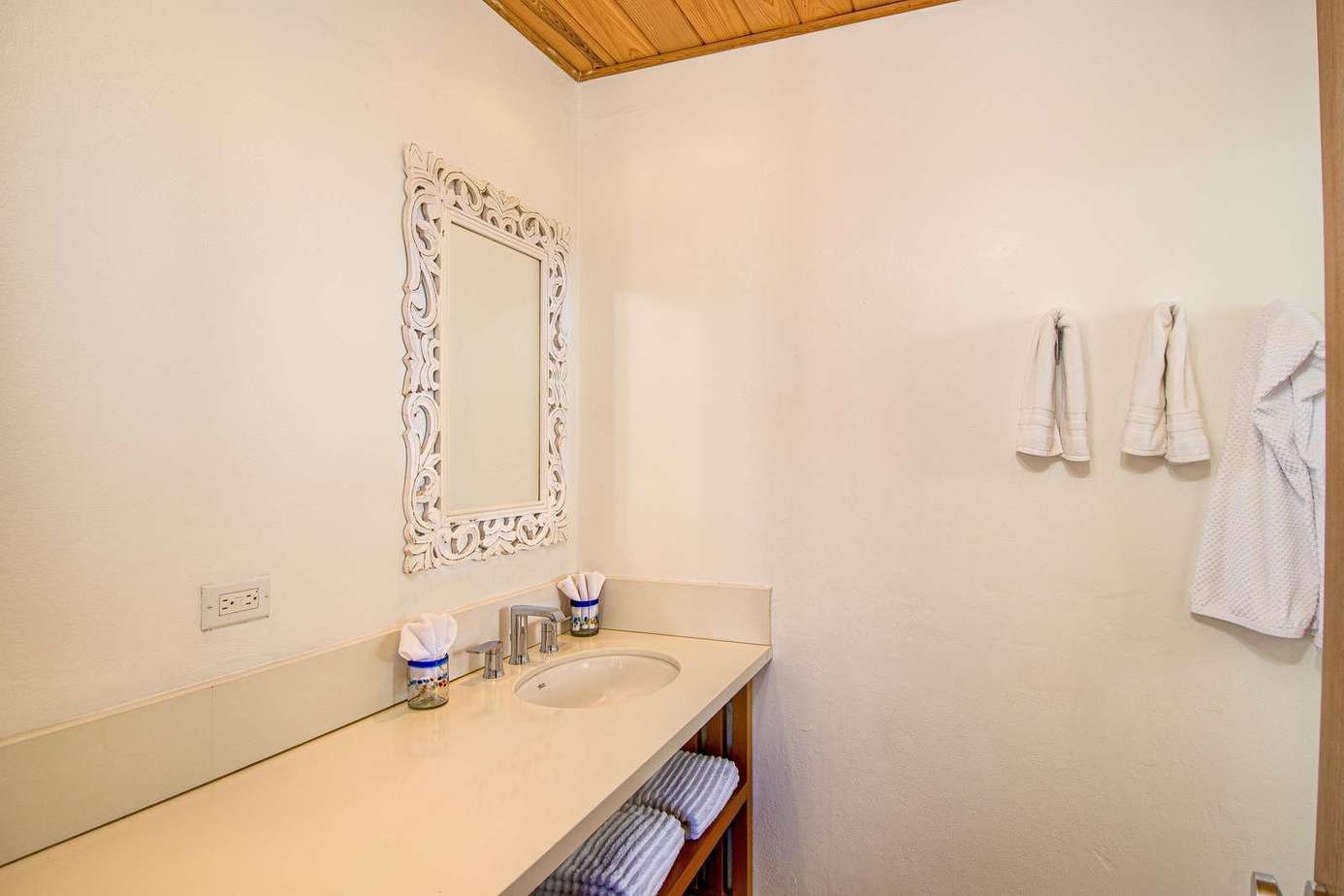 Bright, airy bathroom with modern fixtures and cozy towels