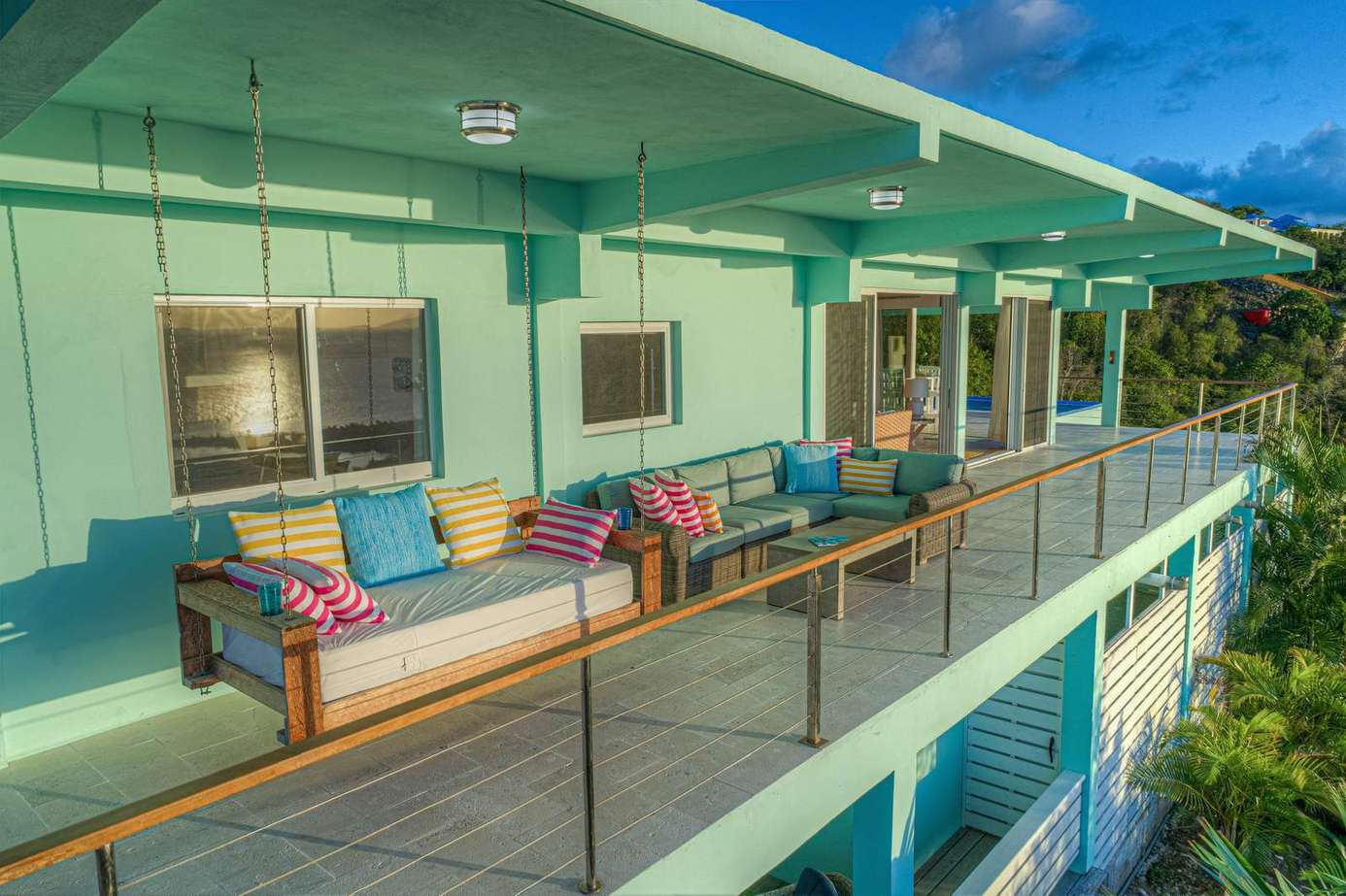 Spacious outdoor deck with cozy seating and sunset views