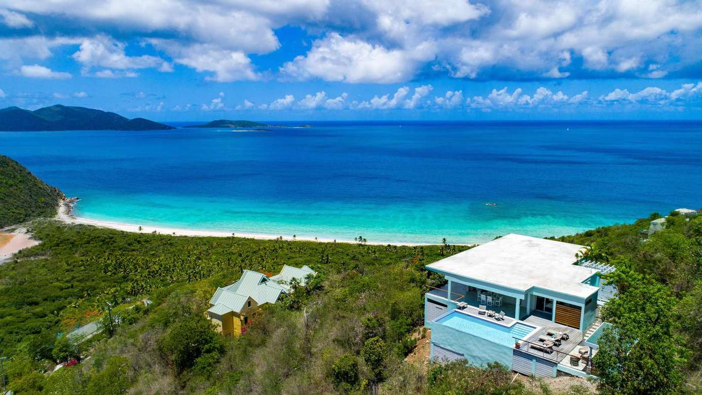Secluded oceanfront retreat with panoramic beach views