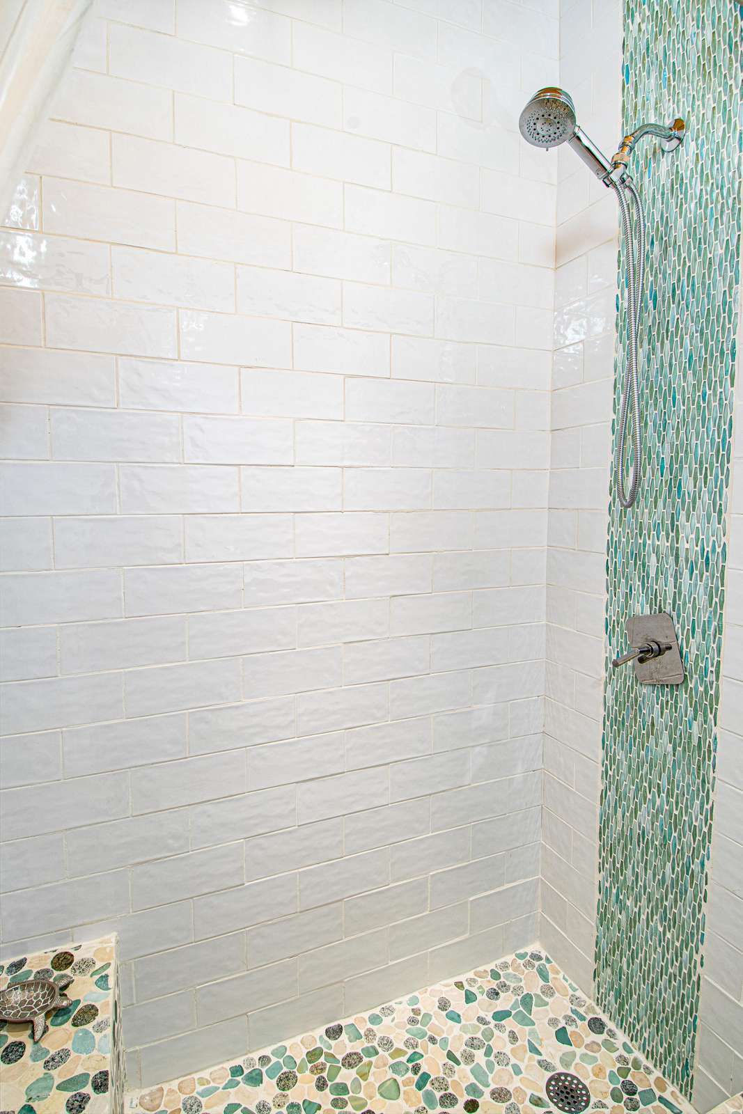 Refreshing walk-in shower with natural stone accents