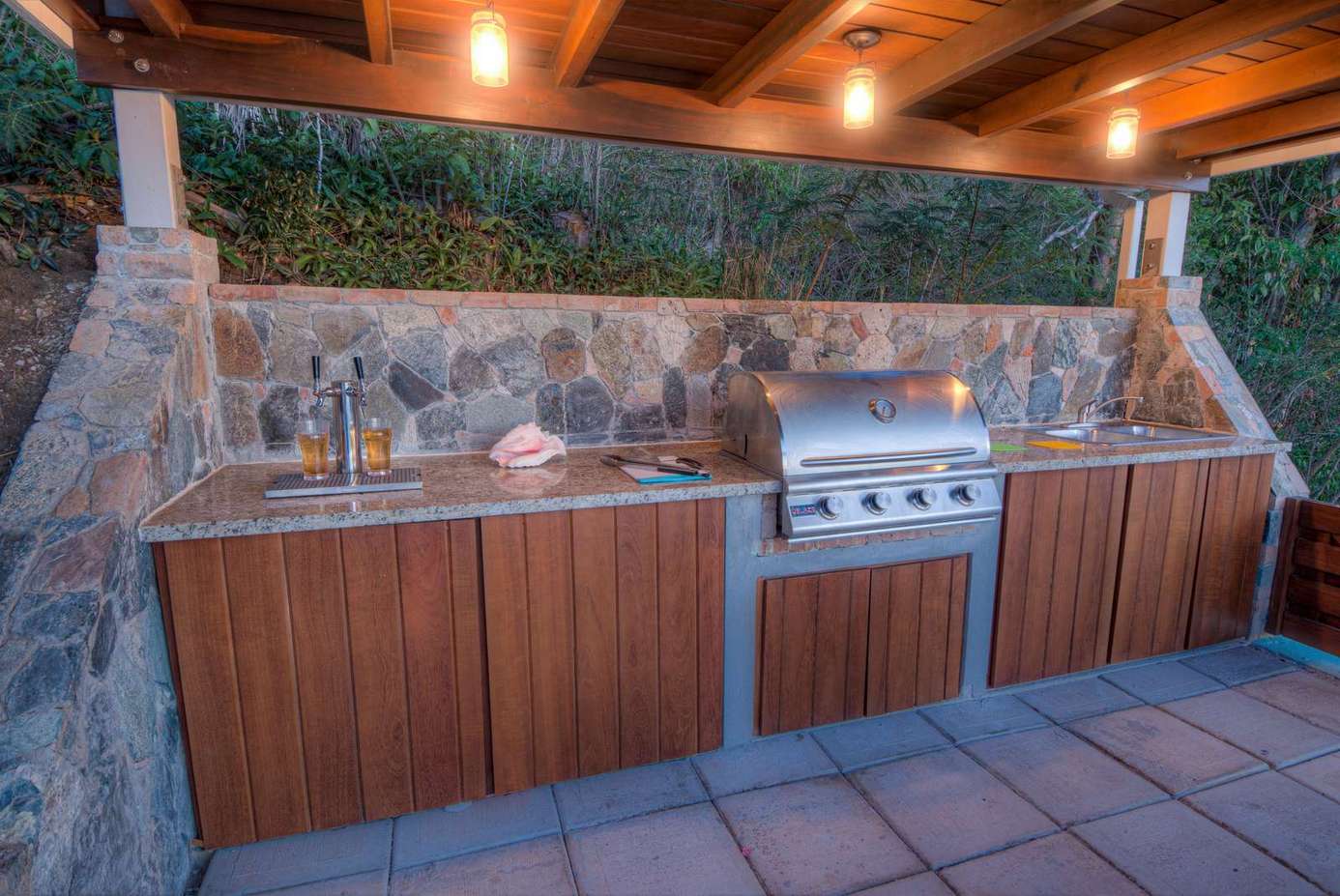 Outdoor kitchen with stone accents and built-in grill