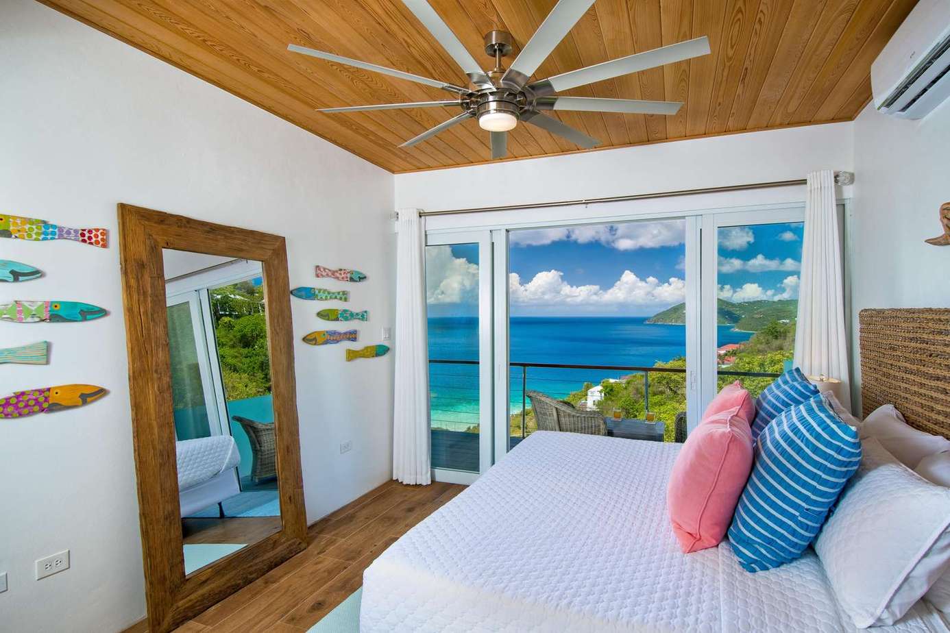 Oceanfront bedroom with panoramic water views and coastal charm