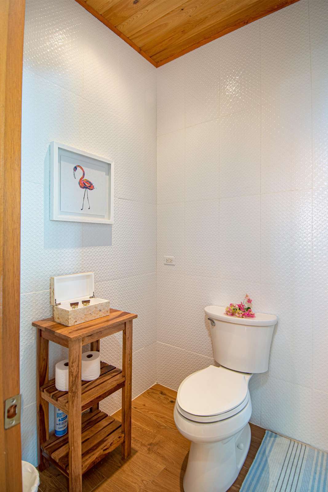 Cozy half-bath with warm wood accents and natural light