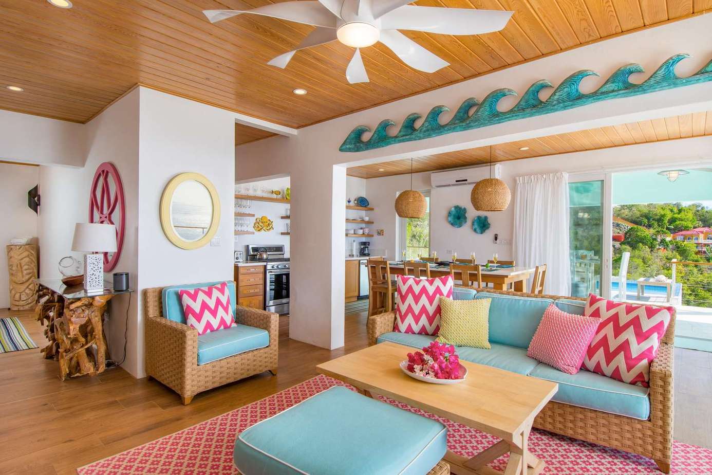 Bright and airy living room with vibrant coastal decor and garden views