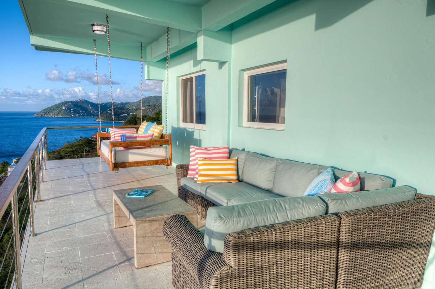 Spacious ocean-view patio with cozy seating for sunset relaxation