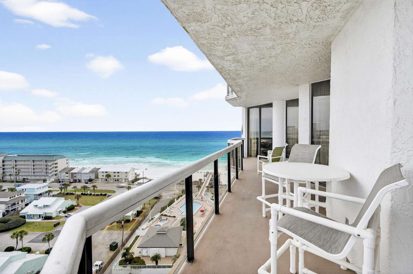 Oceanfront balcony with panoramic sea views and cozy seating - property