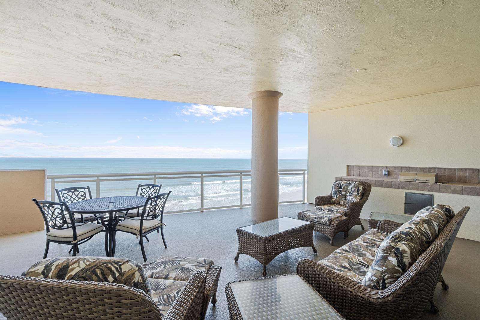 Spacious oceanfront patio with stunning sea views and cozy seating - property