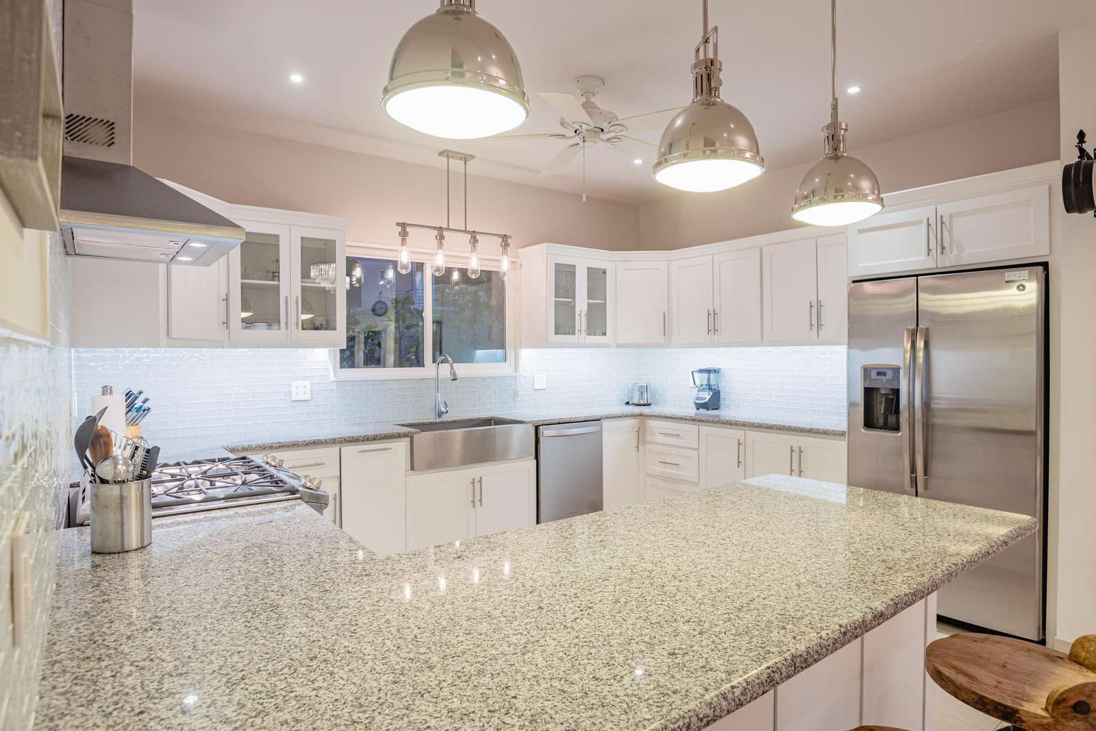 Fully stocked gourmet kitchen, with breakfast bar, granite countertops and stainless steel appliances