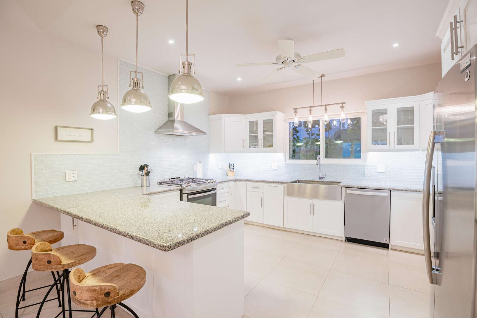 Fully stocked gourmet kitchen, with breakfast bar, granite countertops and stainless steel appliances