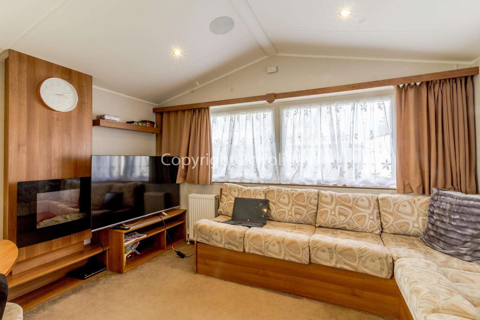 Cosy living area with a smart TV and electric fire