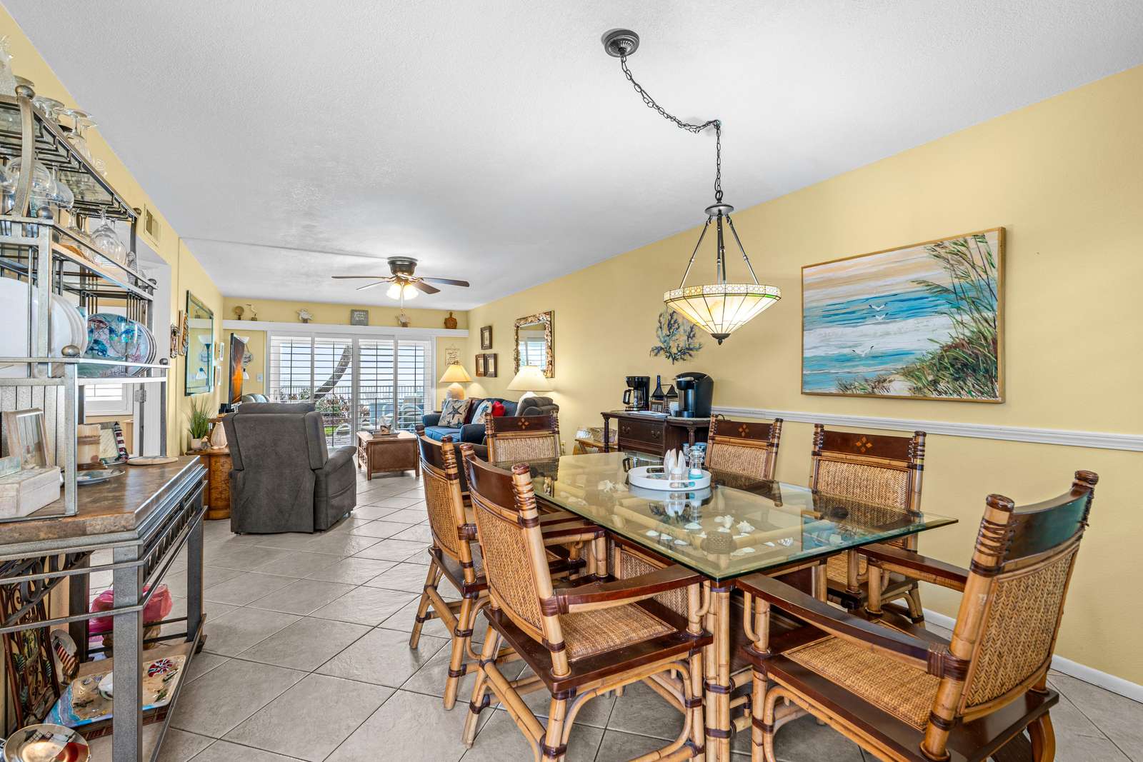 Spacious dining area with elegant glass table and cozy seating - property