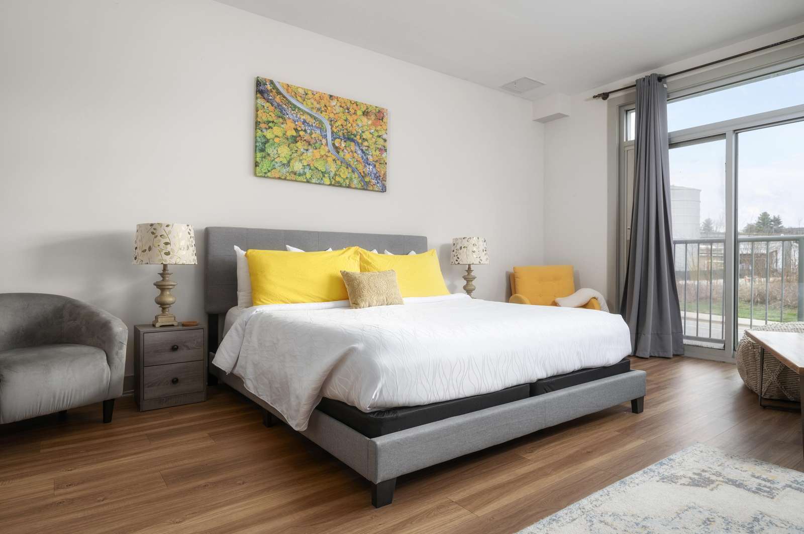 Bright and airy bedroom with city views and cozy seating - property