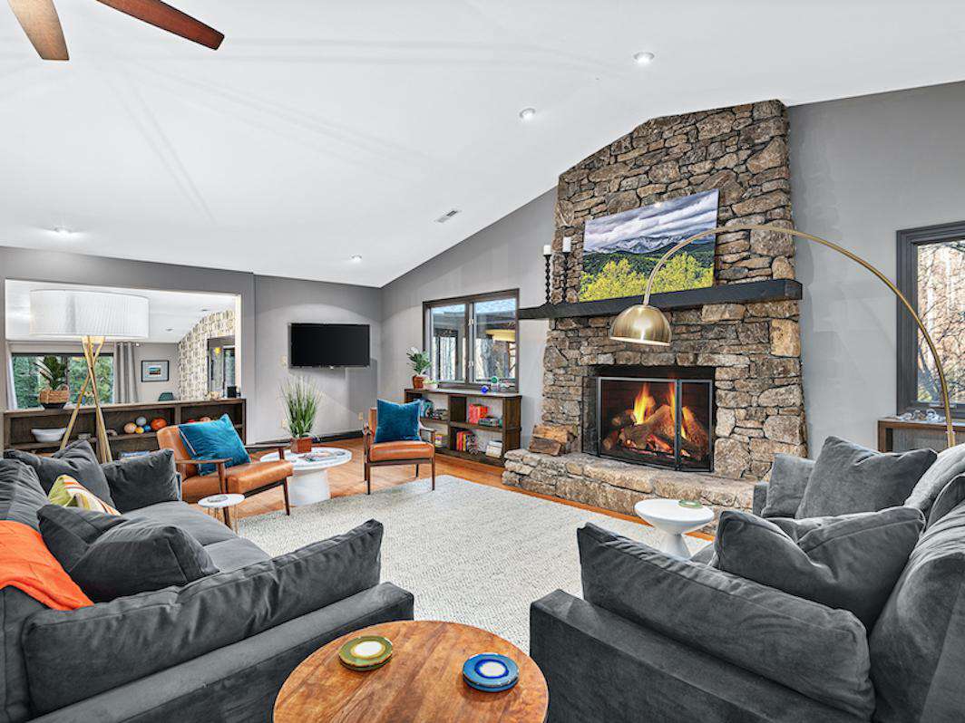 Great Room With Floor To Ceiling Stone Wood Burning Fire Place - property