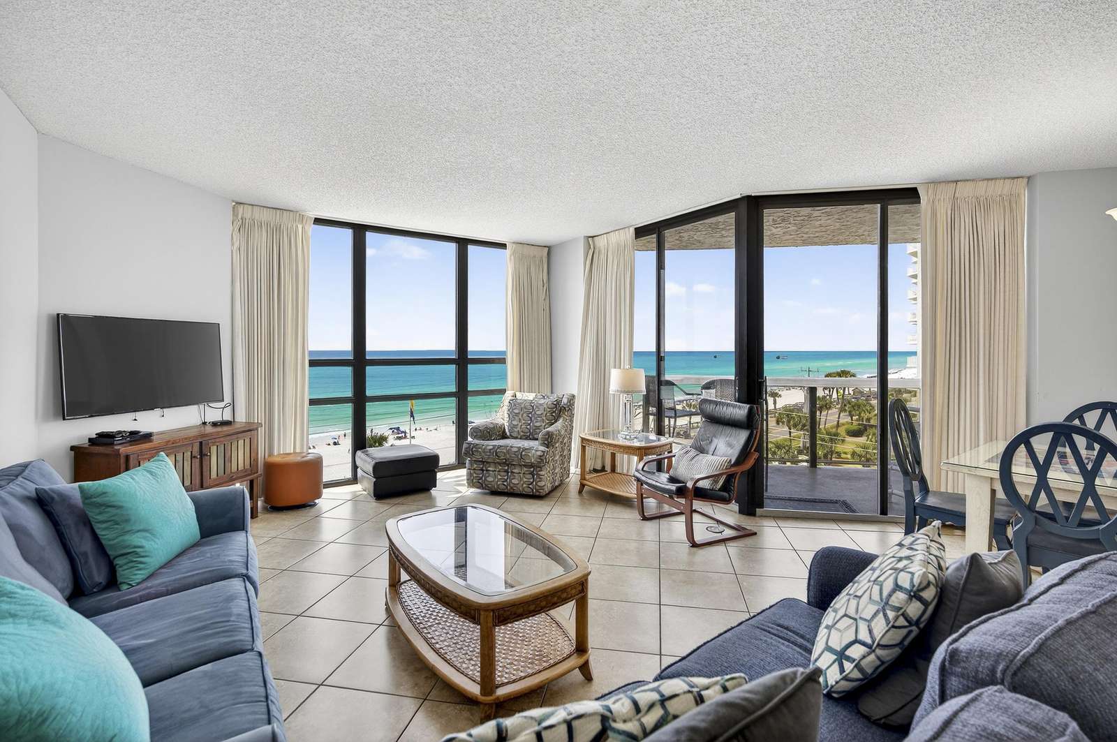 Spacious living room with panoramic ocean views and natural light - property