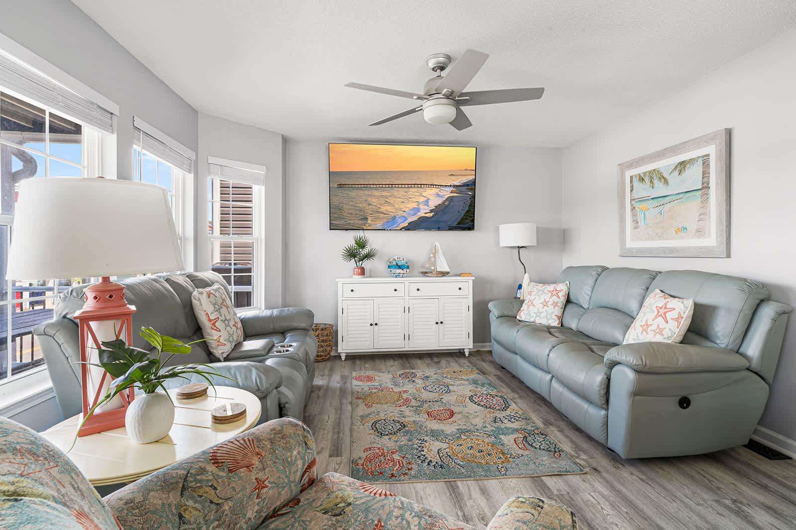 Bright and airy living room with cozy seating and ocean views - property