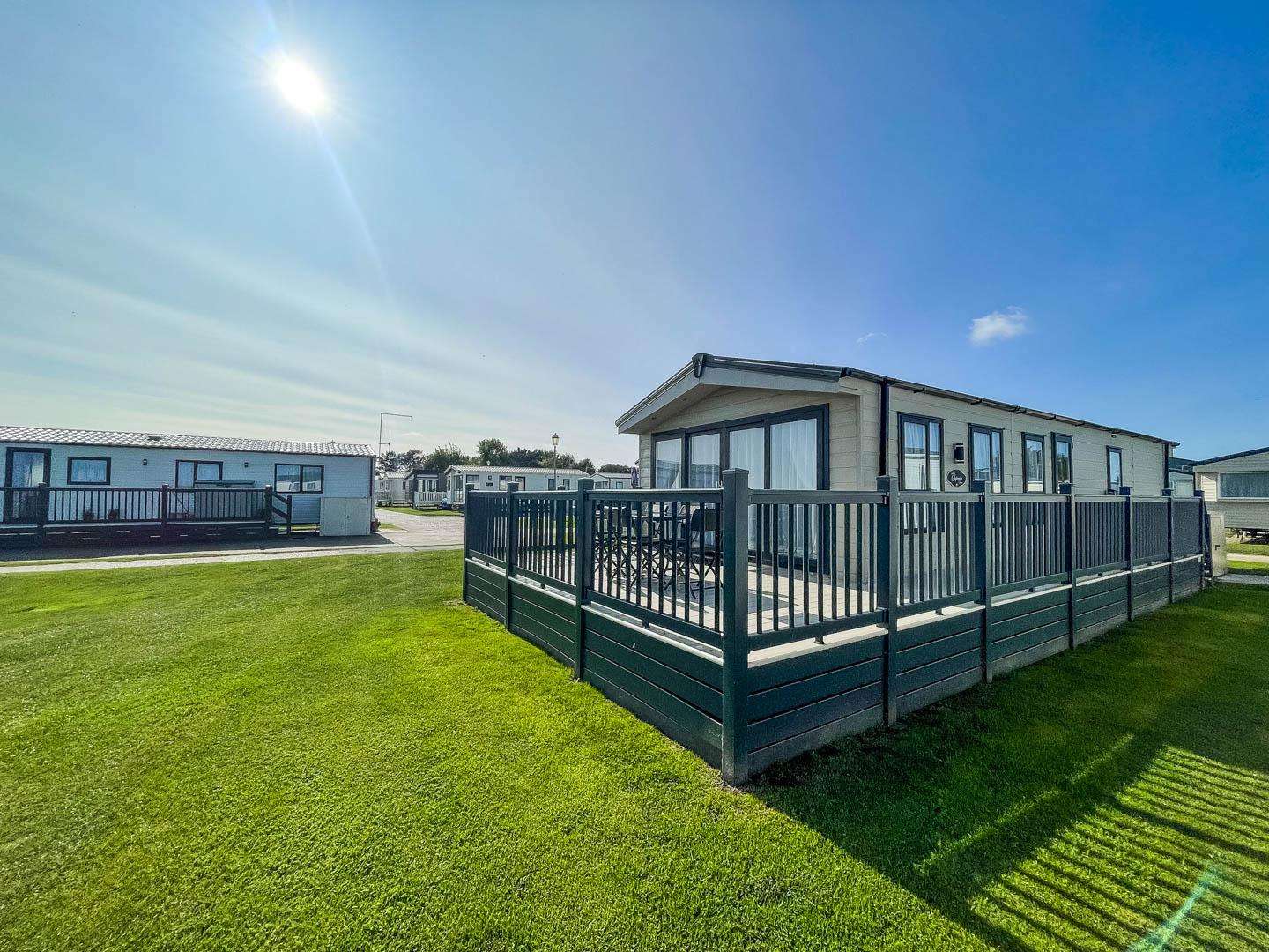 Treat yourself to a romantic getaway UK in a cosy lodge with decking and sea views at Broadland Sands Holiday Park, the ideal spot for British staycations. - property