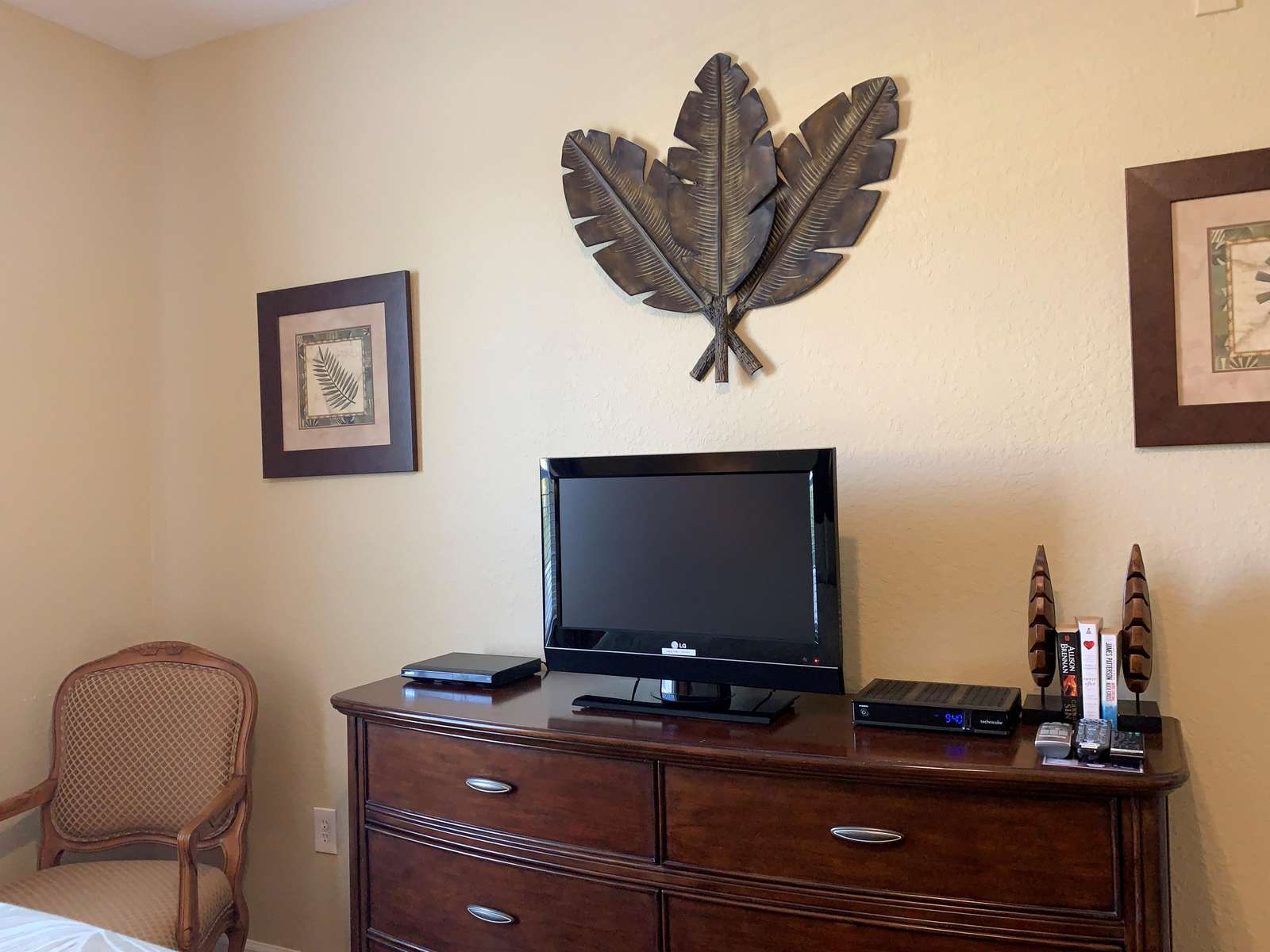 Flat screen TV, DVD, and chair in second bedroom