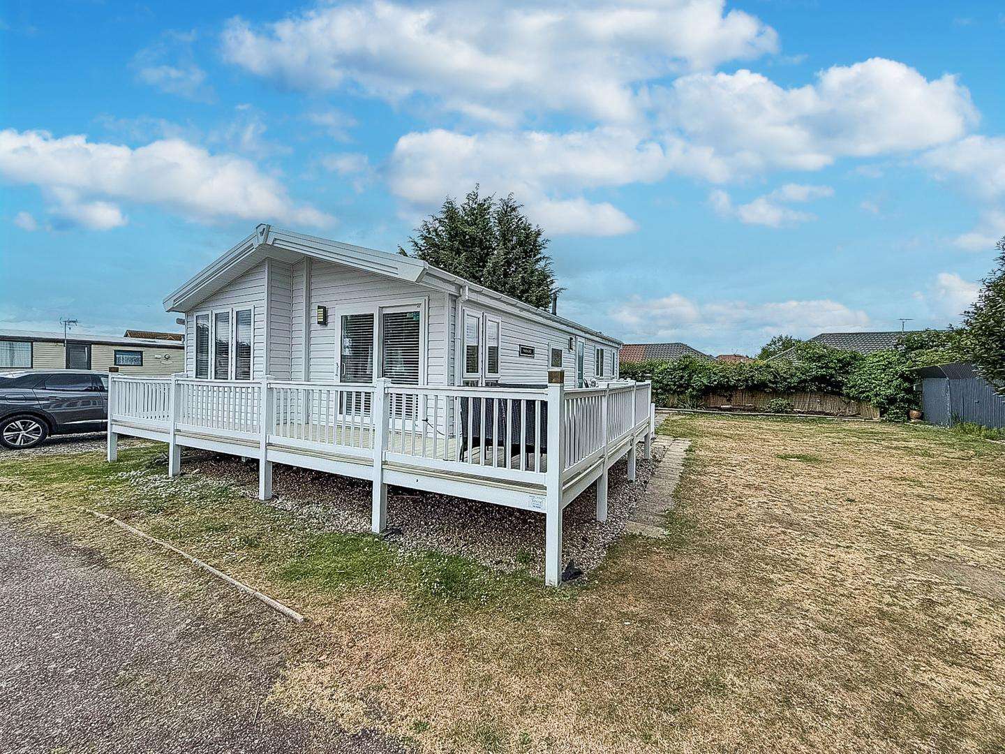 Whether you're planning a romantic getaway in the UK or a last-minute staycation, a lodge with decking at Breydon Water Holiday Park Norfolk provides the ideal retreat. - property