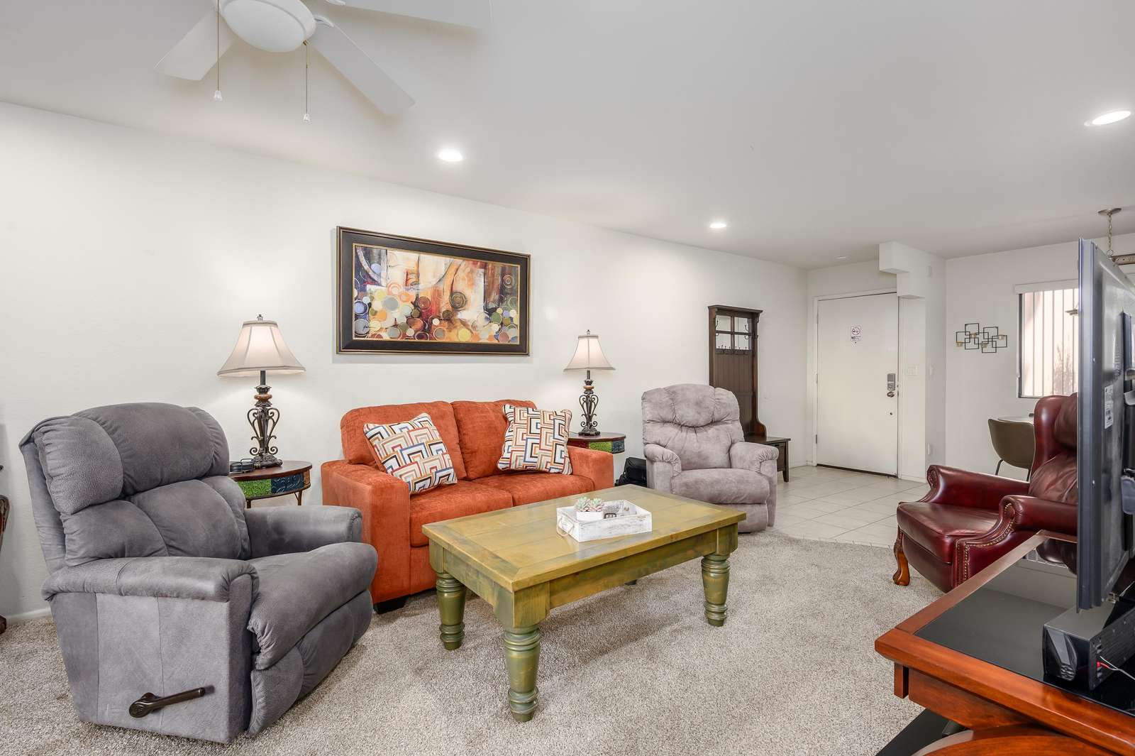 Cozy living room with plush seating and warm lighting - property