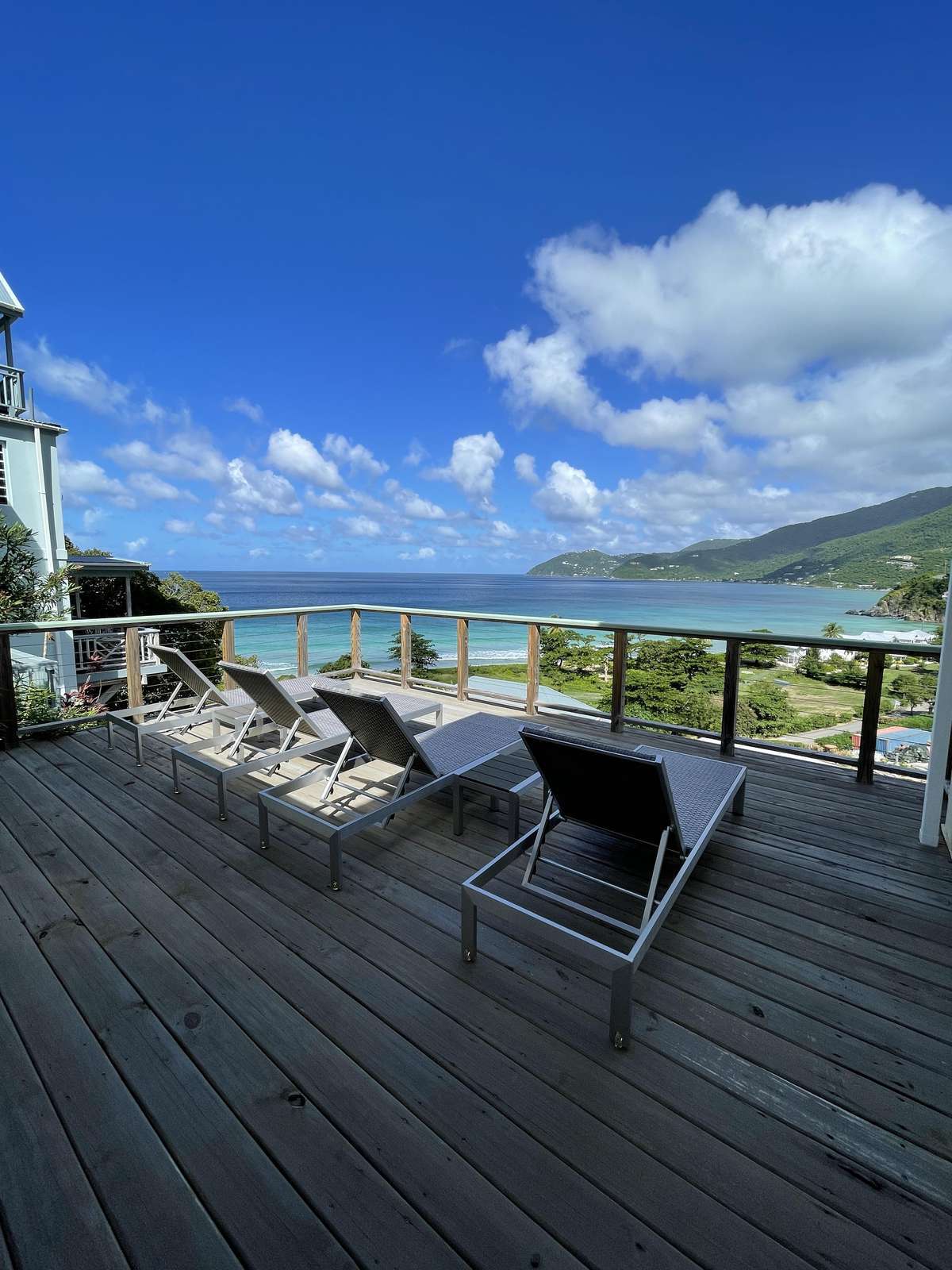 Spacious oceanfront deck with panoramic sea views and lounge chairs