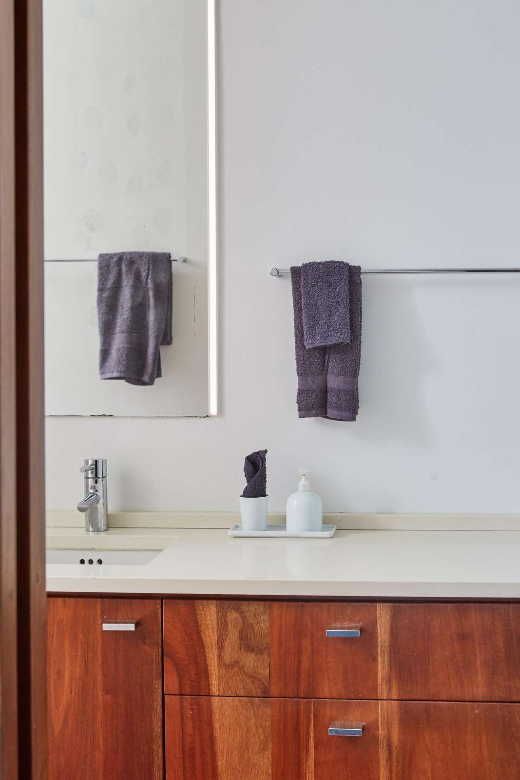 Sleek bathroom vanity with rich wood tones and modern fixtures