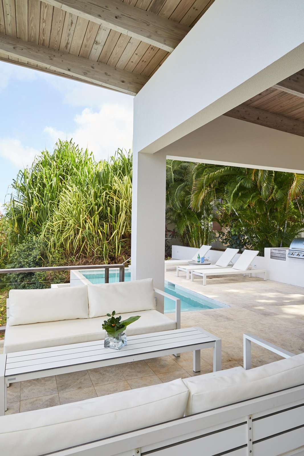 Spacious outdoor patio with cozy seating and pool views