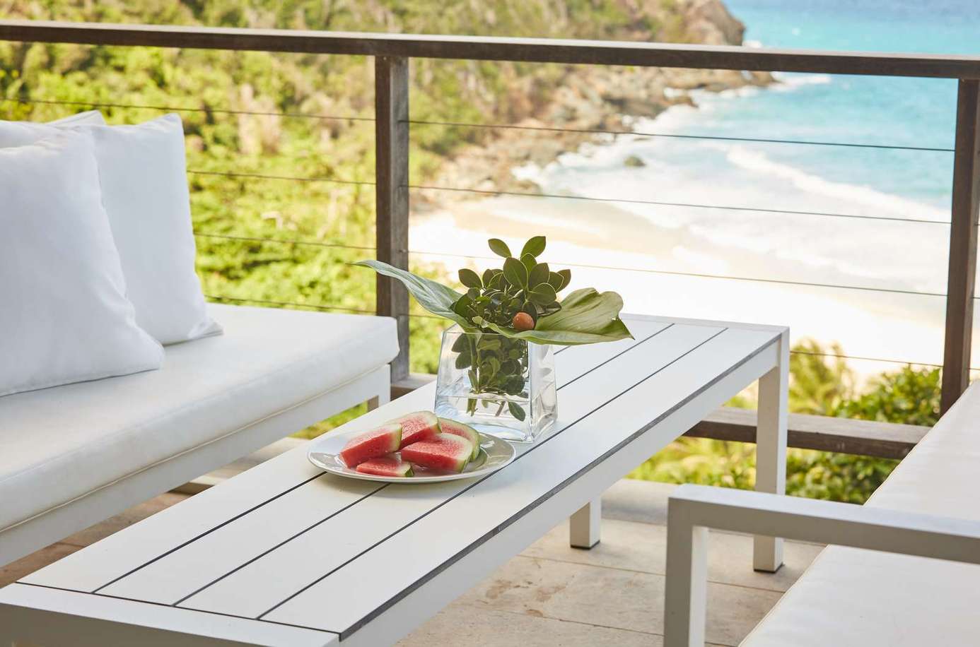 Oceanfront patio with cozy seating and refreshing views