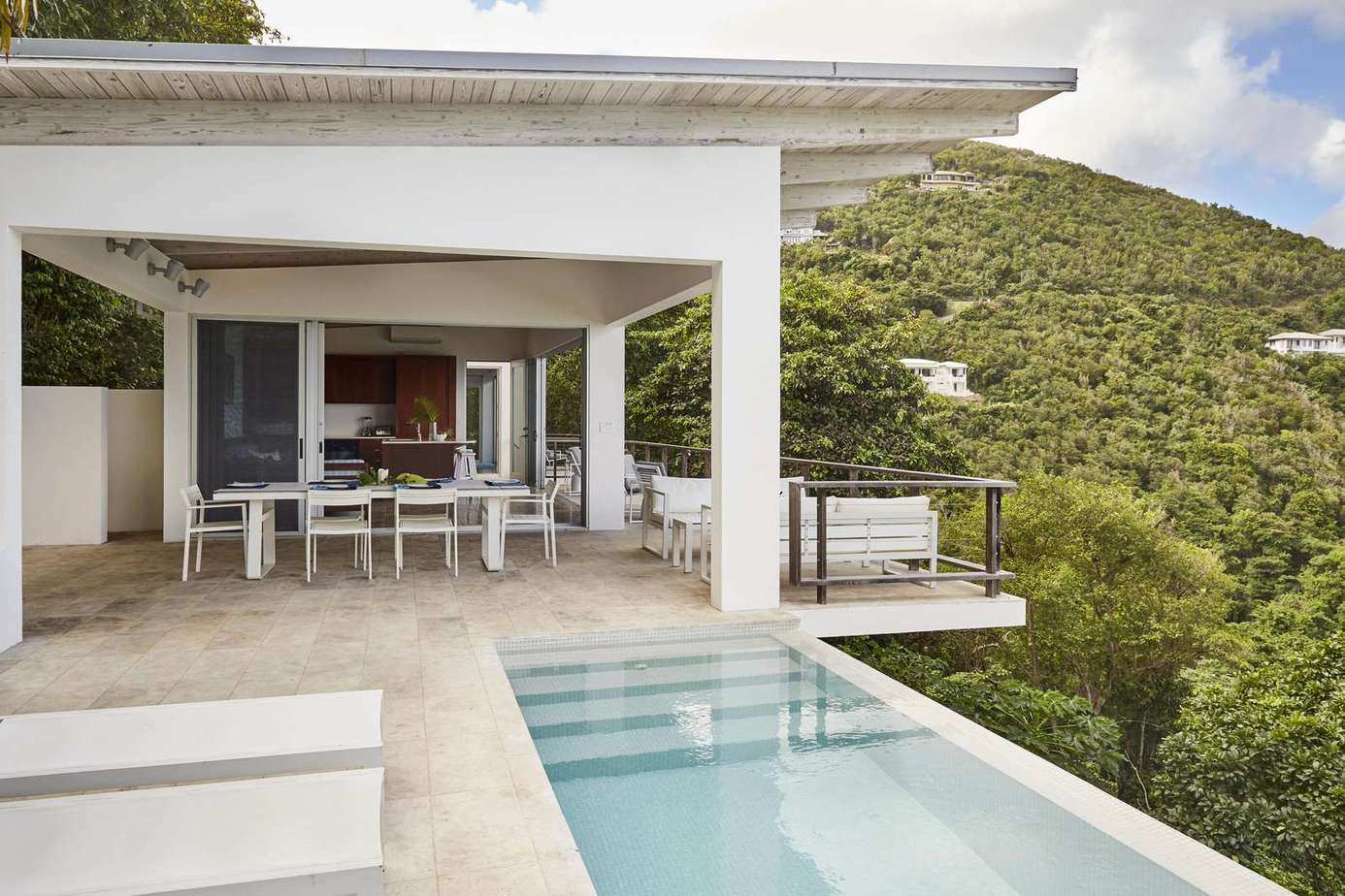 Secluded patio with infinity pool and panoramic hillside views