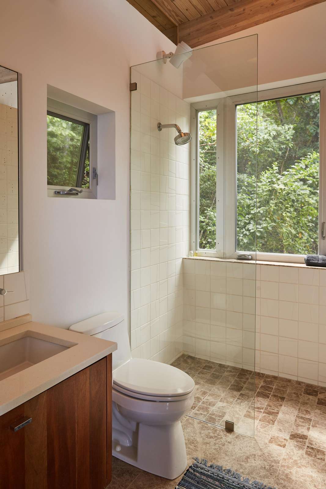 Bright bathroom retreat with forest views and natural light