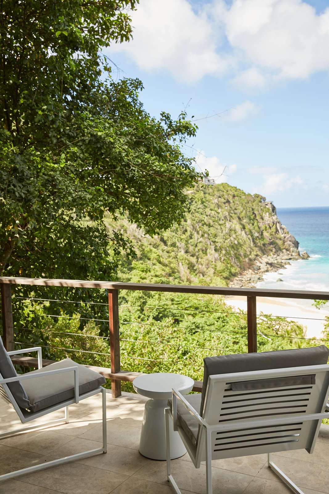 Cozy balcony retreat with stunning ocean and cliff views