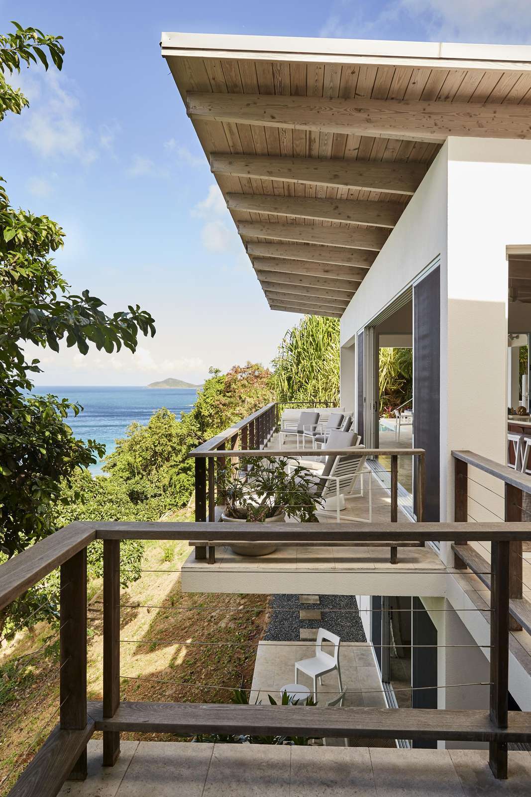 Secluded balcony with ocean views and tropical breeze