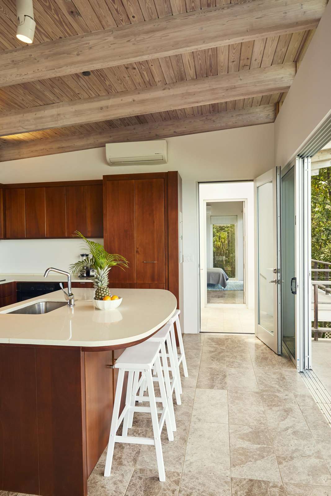 Bright kitchen with vaulted ceilings and garden views