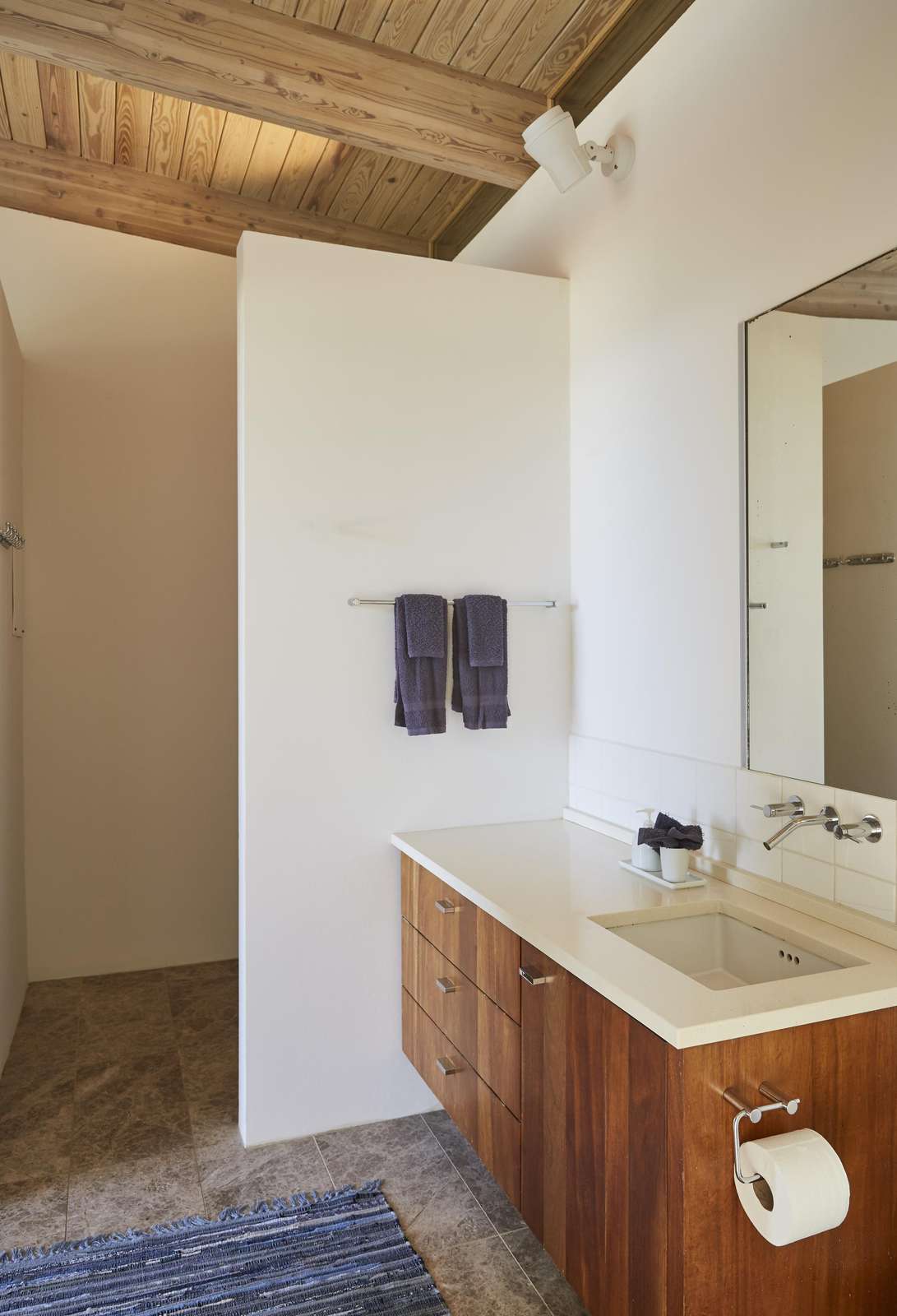 Bright bathroom with modern wood accents and spacious shower
