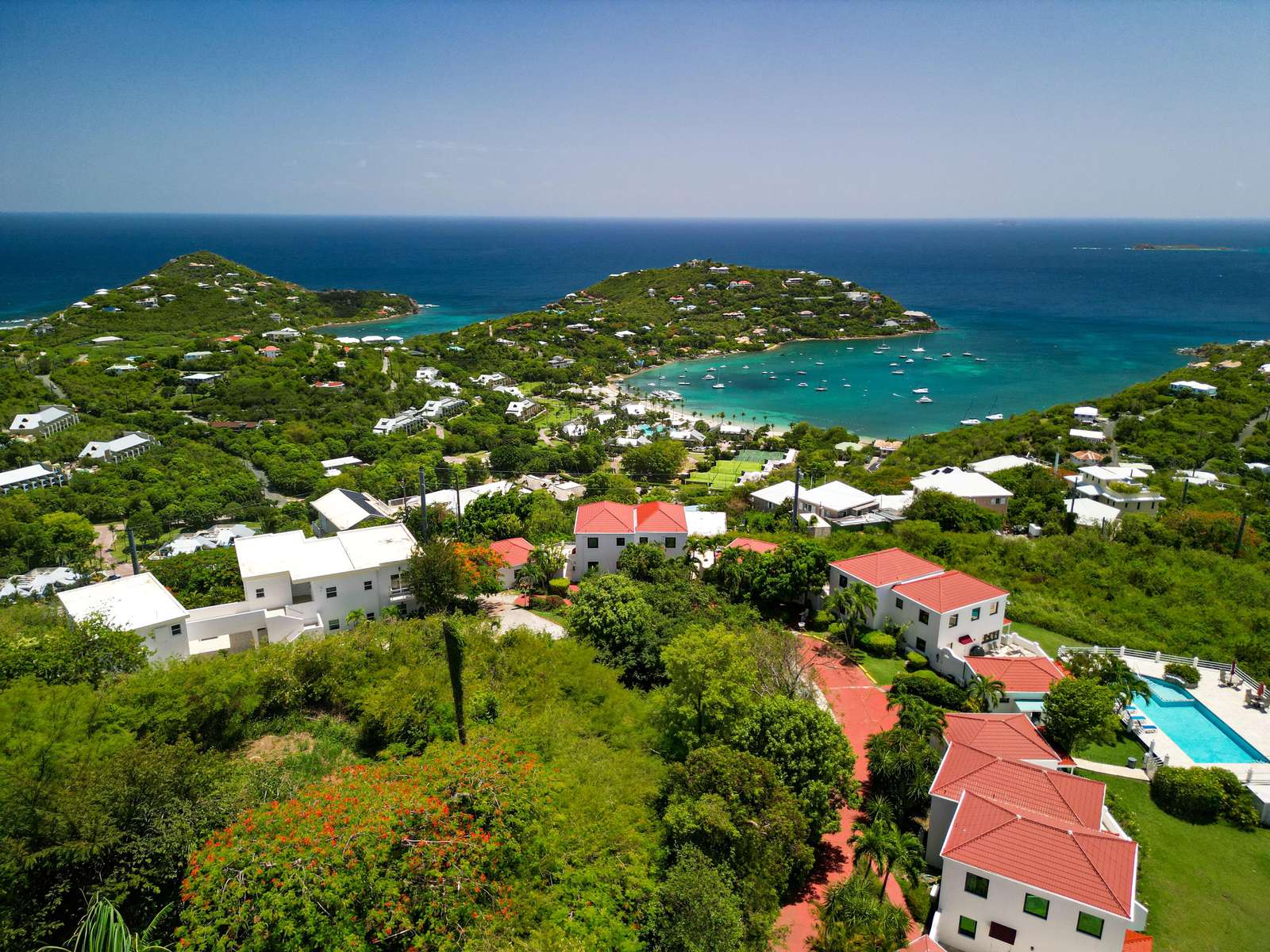 Breathtaking hillside views overlooking vibrant coastal homes and ocean. - property