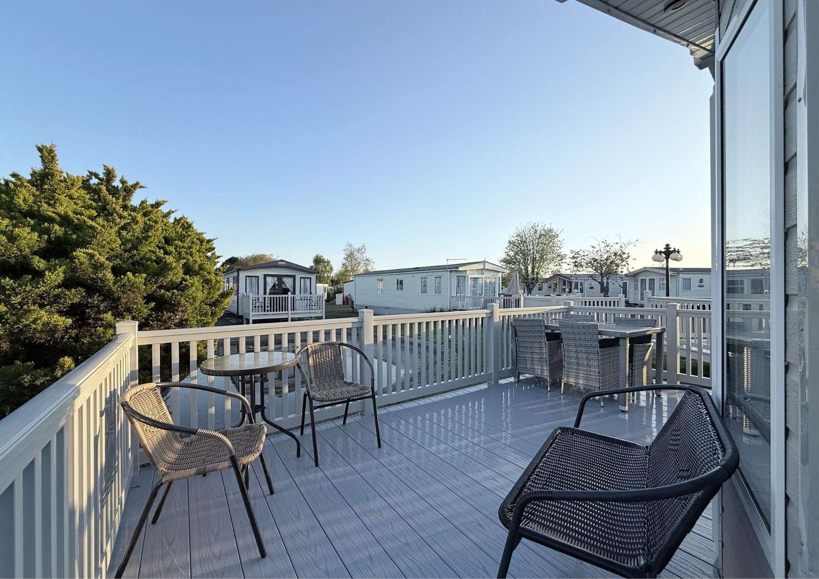 The outisde decking on this modern caravan in Skegness is the perfect place to relax and unwind in the summer sunshine. Overlooking the pond it is so relaxing. - property