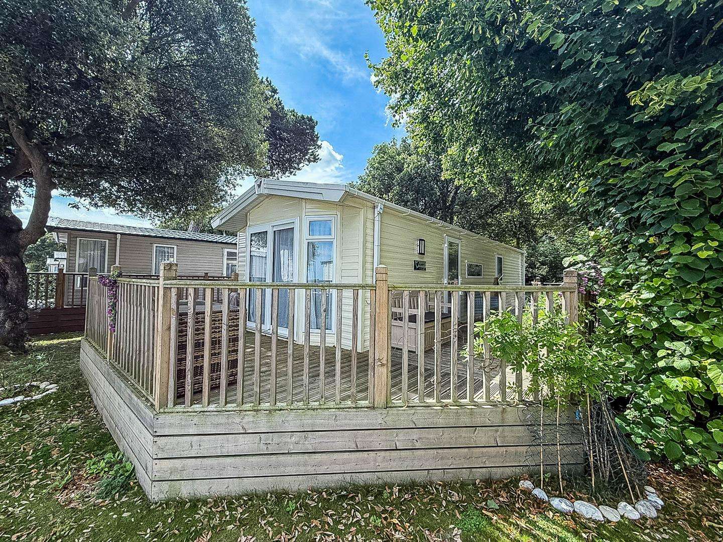 Enjoy the decking and outdoor space for your next coastal getaway. - property