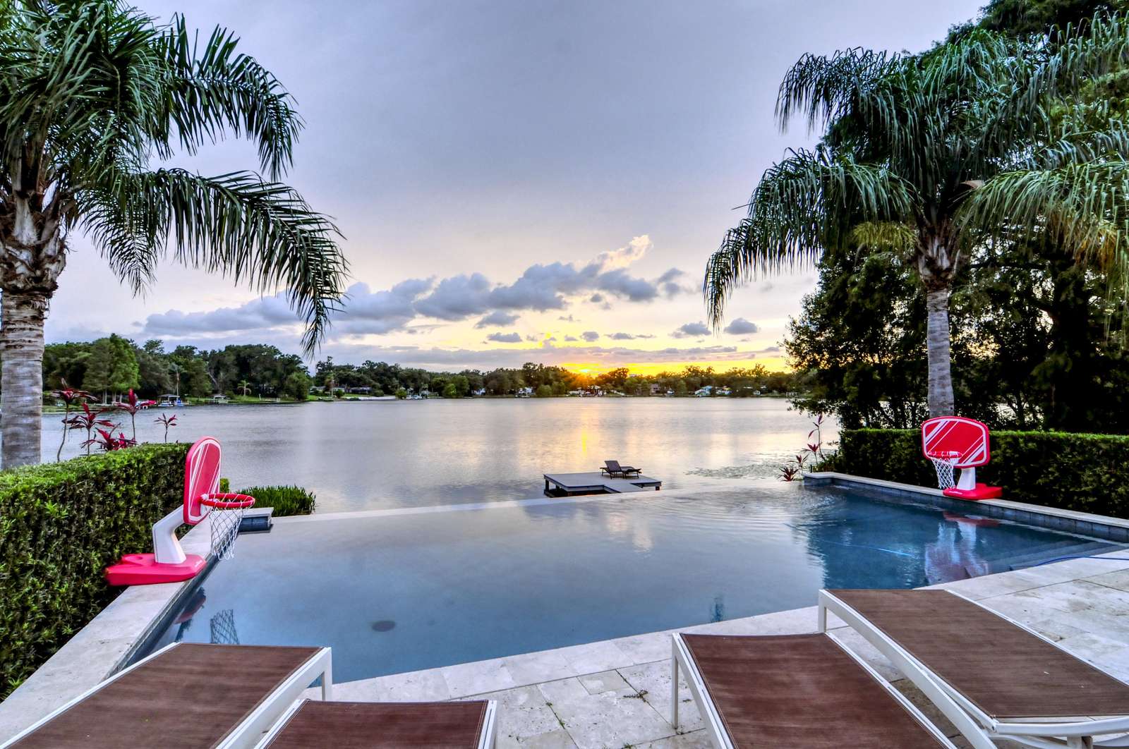 Unwind in Paradise: Lounge on multiple loungers, play basketball in the infinity pool, and luxuriate in the spacious lounge and daybed, creating unforgettable memories in your private haven. - property