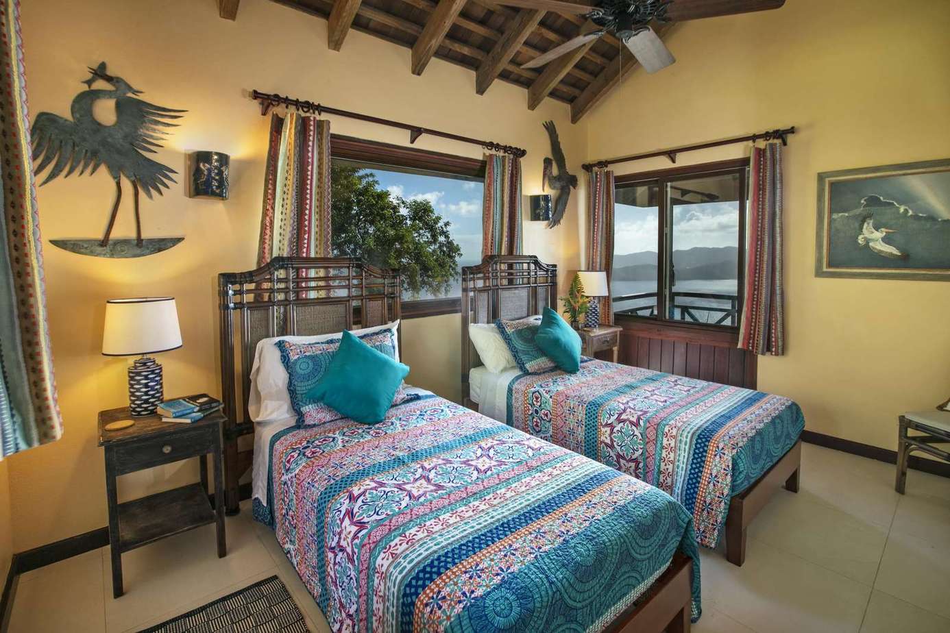 Cozy twin bedroom with tropical decor and ocean views