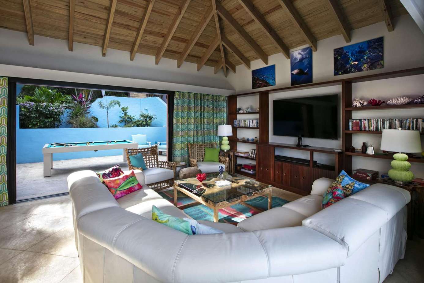 Spacious living room with stunning pool and water views