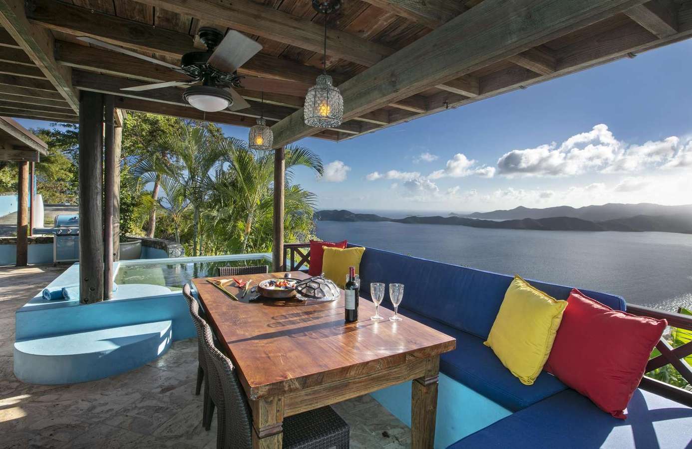 Spacious covered patio with panoramic water views and vibrant seating