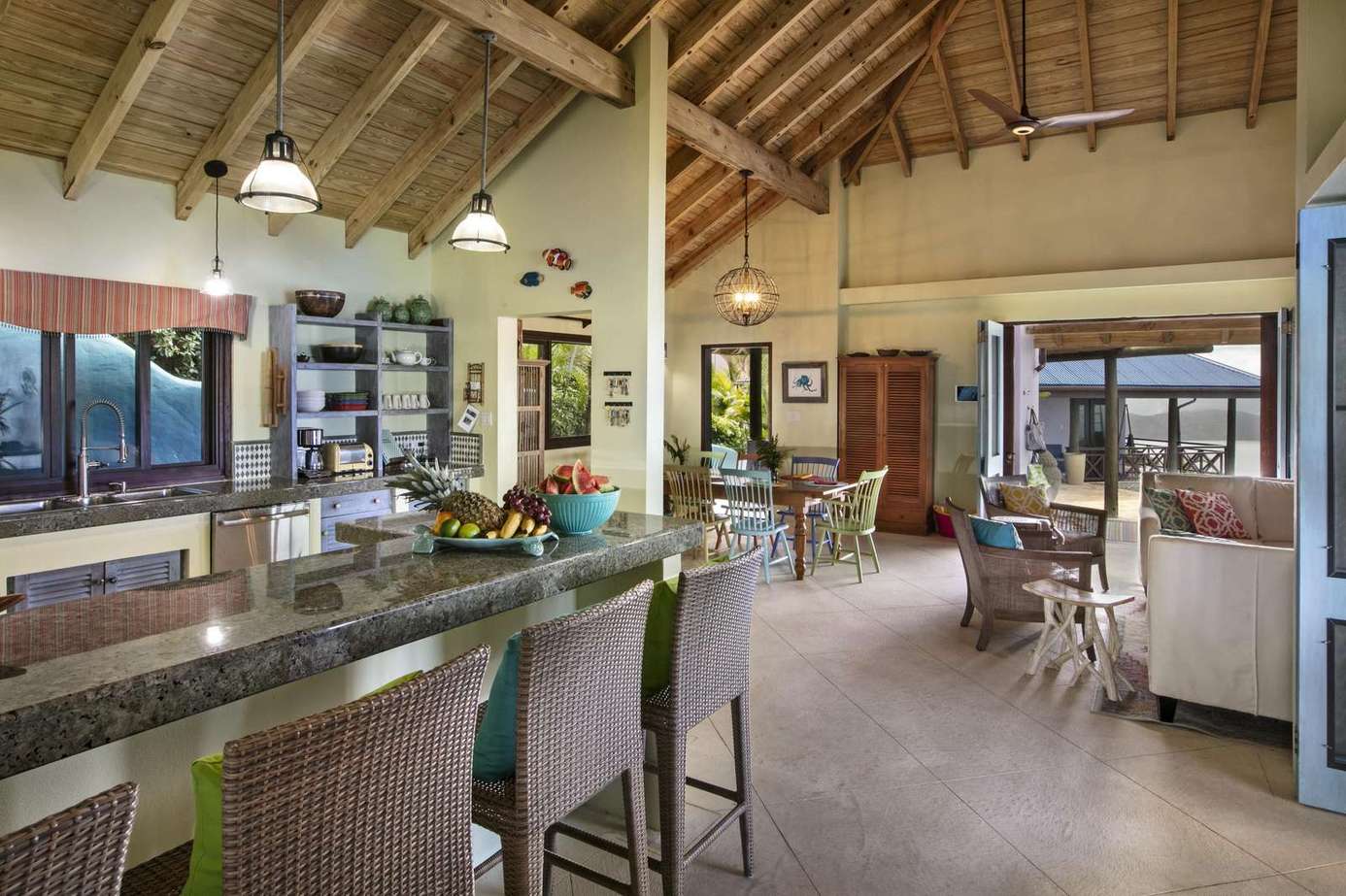 Spacious open-concept kitchen and living area with vaulted ceilings and scenic views.