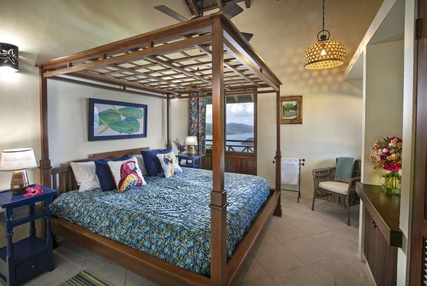Spacious bedroom with elegant canopy bed and cozy seating area