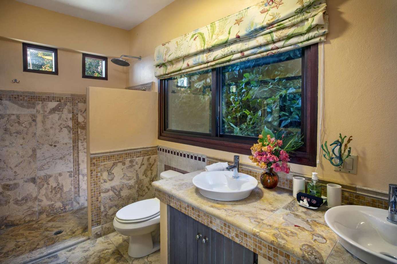 Cozy bathroom retreat with elegant stone accents and garden views