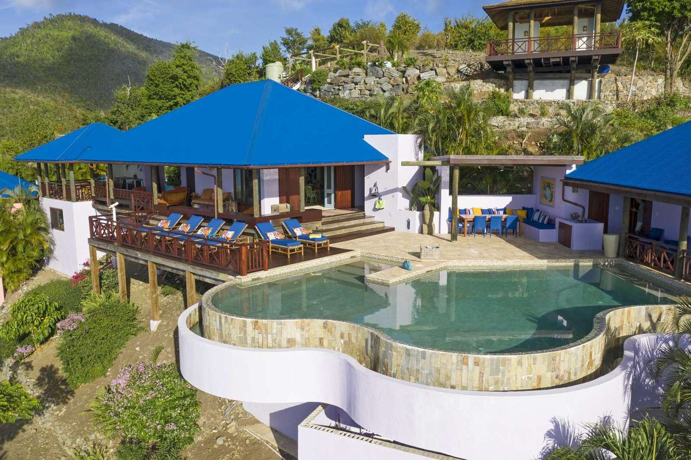 Infinity pool and shaded lounge with stunning hillside views