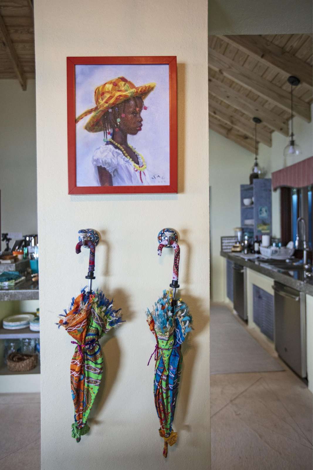 Charming entryway with colorful umbrella stand and art display