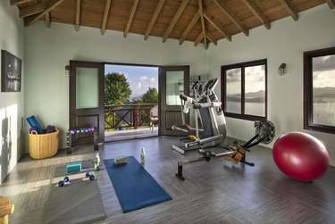 Bright home gym with scenic views and vaulted ceilings
