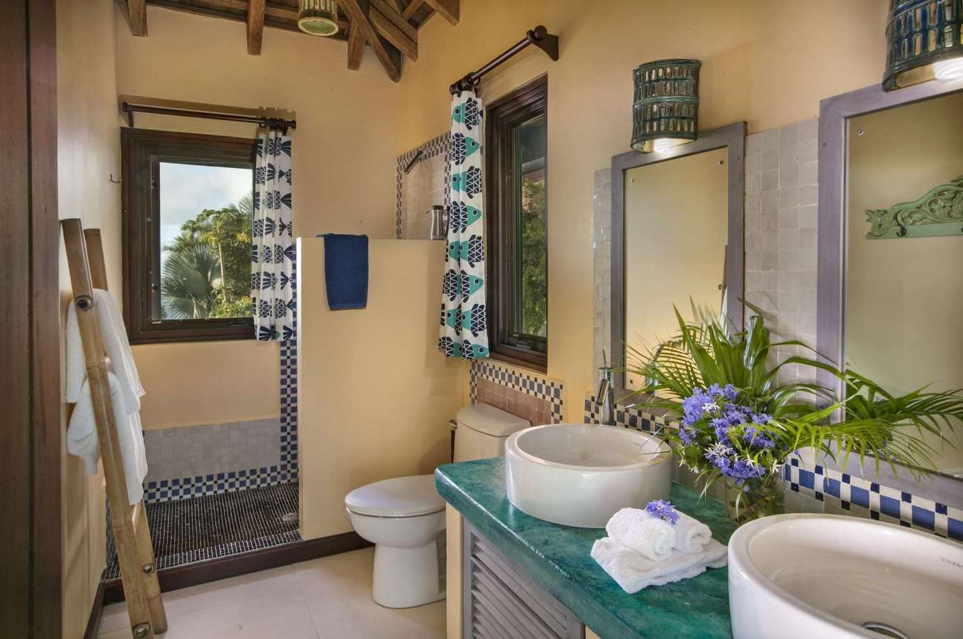Bright, airy bathroom with modern double sinks and garden view